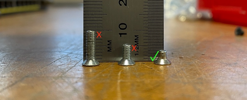 A close up of screws

Description automatically generated